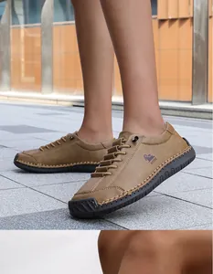 Close-up of brown hand-stitched leather loafers showing intricate craftmanship details