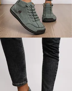 Detail view of teal hand-stitched casual ankle boots with unique embossed logo design