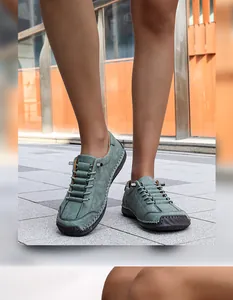 Detailed view of handmade stitched men's outdoor casual loafers on pavement