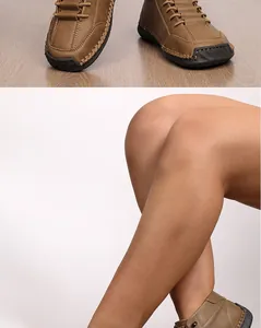 Close-up of hand-stitched casual tan boots showing craftsmanship and textured leather
