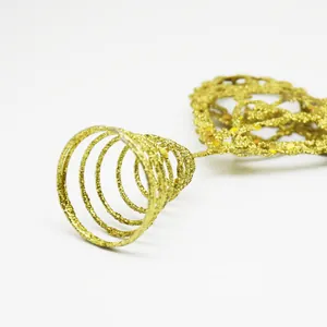 Detailed macro view of gold glitter spiral base for Christmas tree topper decoration