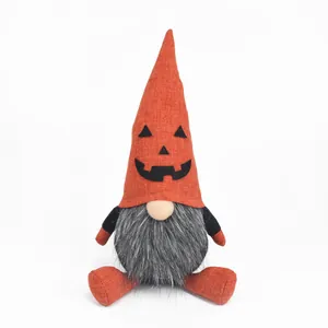 Detail shot of a Halloween gnome ornament with orange pumpkin face and fluffy beard.