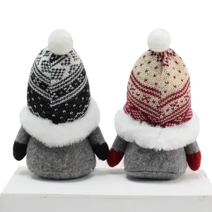 Back view of two Nordic knitted gnomes showing the detailed texture of hats and white fur