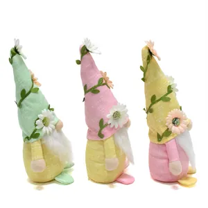 Detail view of three colorful spring gnome dolls with floral hats and white beards
