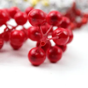 Détail macro de baies de houx rouges artificielles pour décoration de Noël
