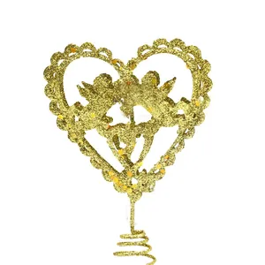 Detailed macro shot of a golden glitter angel heart Christmas tree topper on white.