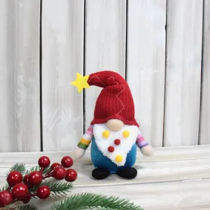Detailed shot of a festive Christmas gnome doll with a red star hat and rainbow arms.