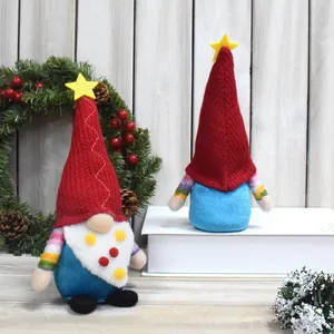 Detailed view of two Christmas gnomes with red knit hats and colorful striped arms.