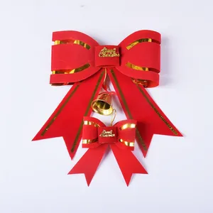 Close-up detail of decorative red and gold Christmas bows with Merry Christmas text