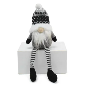 Detailed view of Nordic knitted Christmas gnome doll with long hanging black and white striped legs