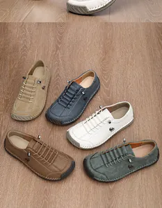 Multi-color selection of hand-stitched wide fit men's casual loafers on wood floor.