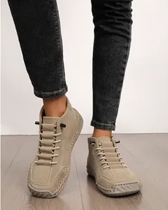 Detailed view of beige hand-stitched women's casual ankle boots with nubuck texture