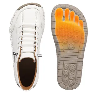 Minimalist white hand-stitched casual shoes featuring an ergonomic comfort sole