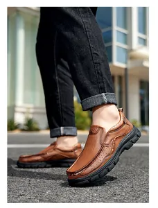 Side detail of men's brown leather outdoor casual shoes with thick black anti-slip soles