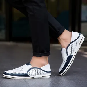 Men's breathable white and navy perforated leather loafers shown in a lifestyle shot