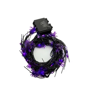 Close-up of purple LED spider Halloween string lights featuring an eight-function battery box