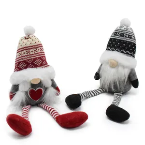 Detailed shot of two Nordic knit gnomes with decorative patterns and long striped legs.