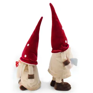 Detailed view of two Christmas gnomes with tall red polka dot hats and white beards.