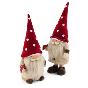 Two adorable Christmas gnomes with resin faces and red polka dot hats on white background