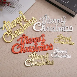 Detailed view of electroplated Merry Christmas charms in gold, silver, and red colors