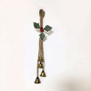 Detail shot of vintage Christmas metal bells hanging on a rustic hemp rope decoration
