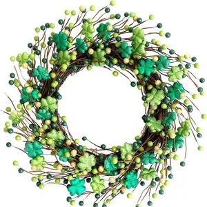 Detail of a St. Patrick's Day wreath featuring green glitter clovers and colorful berries.