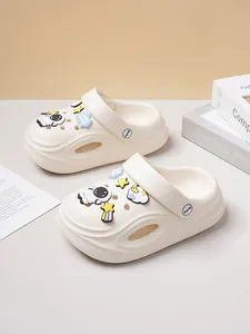 Detail view of cream clogs with cute astronaut and space-themed charms