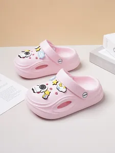 Detailed view of pink kids clogs featuring cute astronaut and star cartoon shoe charms