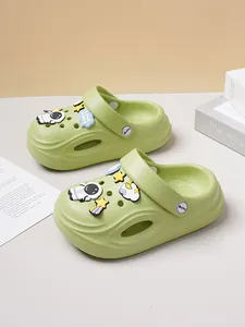 Detailed view of light green clogs with cute astronaut and space-themed charms