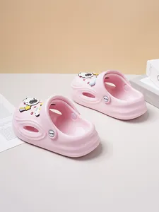 Detailed view of pink children's clogs with cute astronaut and space-themed charms