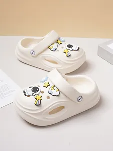 Detailed view of cream children's clogs featuring cute space-themed astronaut charms.
