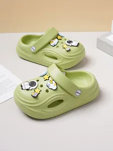 Detail view of comfortable green children's clogs decorated with cute astronaut and stars charms