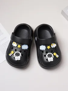 Black children's garden clogs featuring cute astronaut and shooting star charms top view