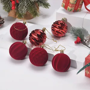 Detailed macro view of red flocked and metallic ribbed Christmas tree hanging ornaments