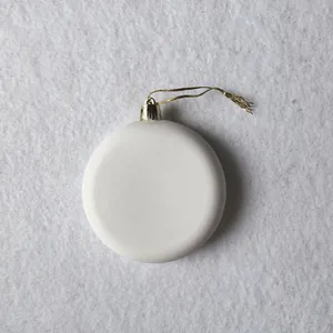 Detailed view of a blank white round ceramic Christmas tree hanging ornament with gold string