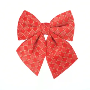 Detailed shot of red velvet Christmas bow with elegant gold diamond grid pattern