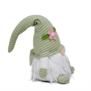Easter plush gnome doll with long green knitted hat and decorative pink flower detail