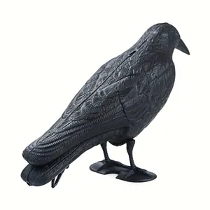 Detailed view of a realistic black crow decoy with feather textures for garden use