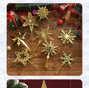 Assorted golden electroplated Christmas tree topper stars and snowflakes on wooden surface.