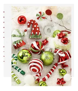 Close-up view of festive Christmas ornaments including painted balls and Santa figures on snow