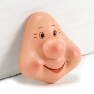 Primer plano de una cara de enano de resina con nariz grande y sonrisa para manualidades DIY.