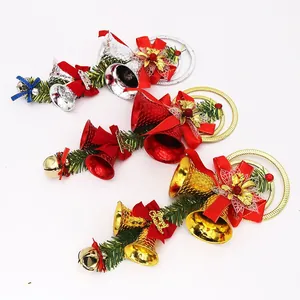 Decorative gold, silver, and red Christmas bell ornaments with pine needles and bows