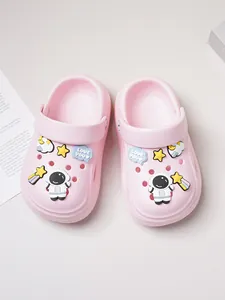 Close-up of pink kids' clogs featuring cute astronaut and star charms for casual wear