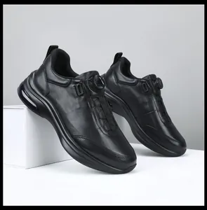 Side view detail of black genuine leather men's casual sneakers featuring a rotary dial closure