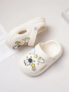 Detailed macro view of cream white clog shoes with cute astronaut and star charms