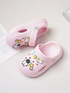 Detailed view of pink toddler clogs with cute astronaut and star charms