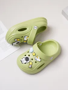 Light green kids garden clogs with astronaut and star charms detail view