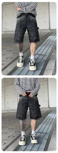 Detailed view of men's loose denim shorts featuring radial rhinestone starburst patterns