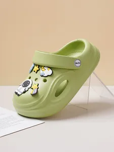 Side view of lime green children's clogs decorated with cute astronaut and star charms