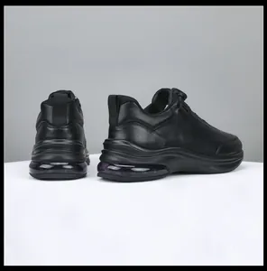 Detailed rear view of men's black leather sneakers featuring thick soles and air cushioning